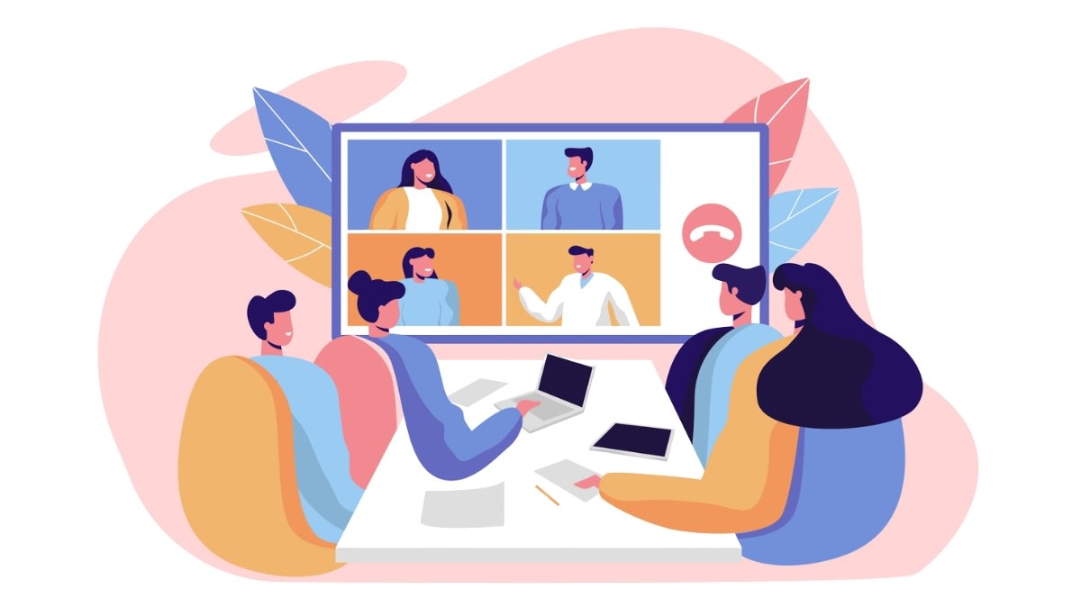 Illustration of a hybrid meeting with four in-person participants collaborating around a table and three remote colleagues shown on a large screen.